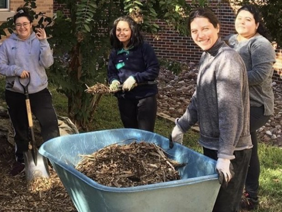 Students doing outdoor community service work on campus
